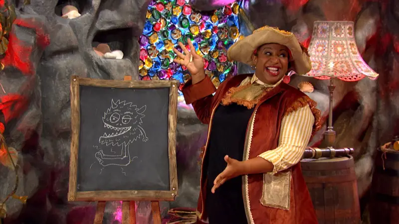 Captain HeyHo i showcasing a chalkboard with a monster drawn on it