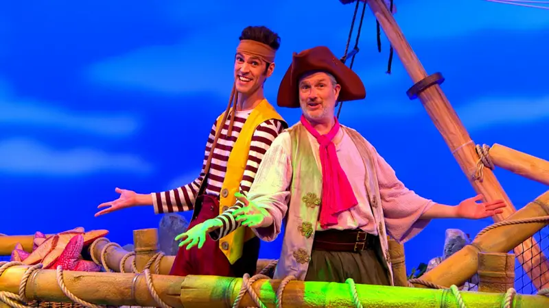 The pirates are singing a song on top of the ship.