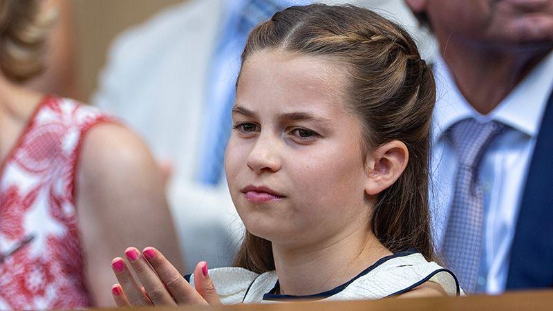 Princess Charlotte ina  white dress sits among others