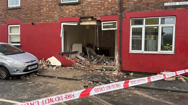 Damage to a house on Currie Road after crash