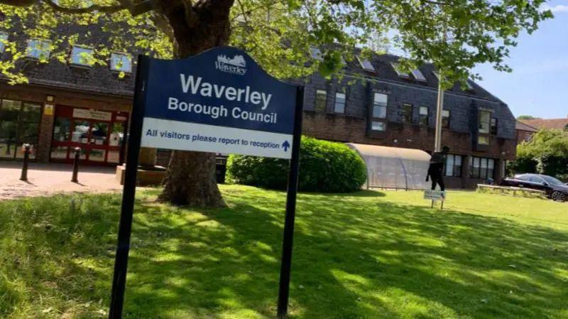 A navy sign which says "Waverley Borough Council".