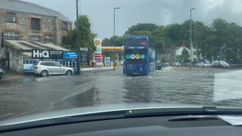 Flash flood hits Truro roundabout amid weather warning - BBC News