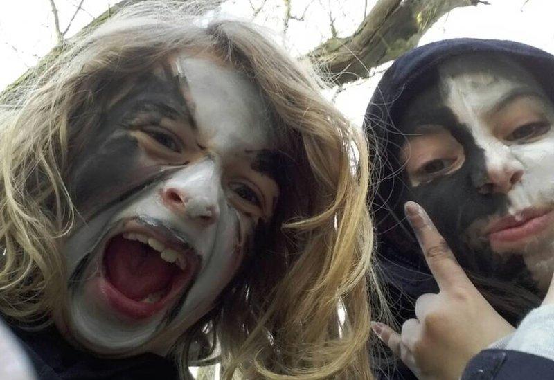 The children in the group wearing heavy metal-style face paint