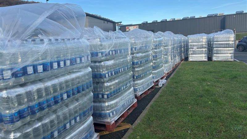 A large number of water bottles on crates