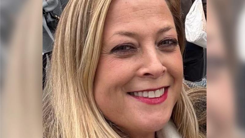 Close-up of Annabel Rook smiling at the camera. She had blonde hair and red lipstick.