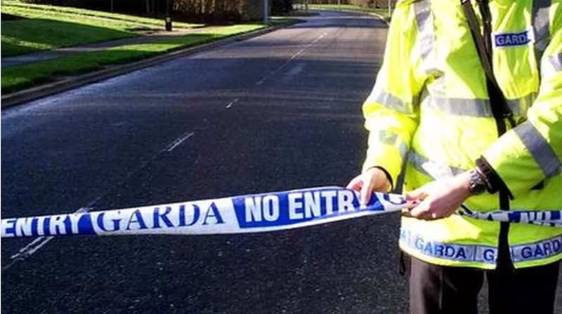 Garda officer with police tape