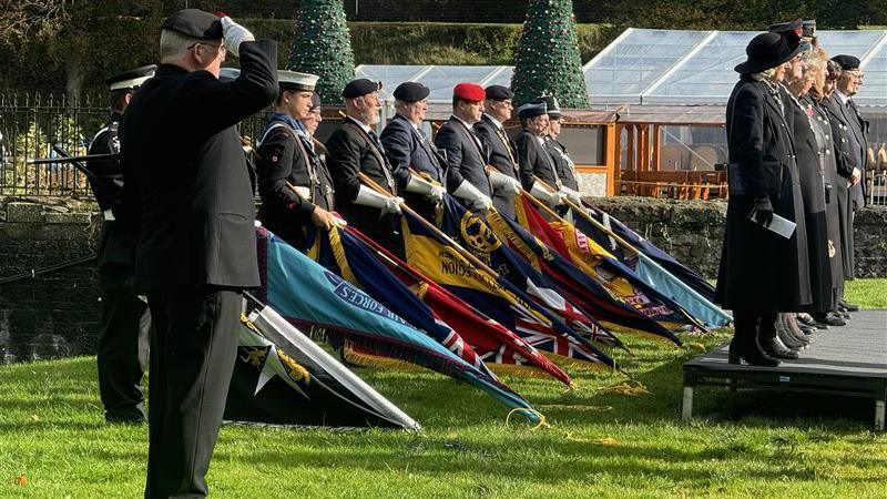 Standard bearers lower their banners at Cardiff Castle's field of remembrance