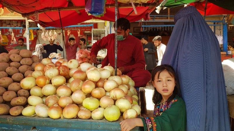 Afghans shop for food in a Kabul bazaar.