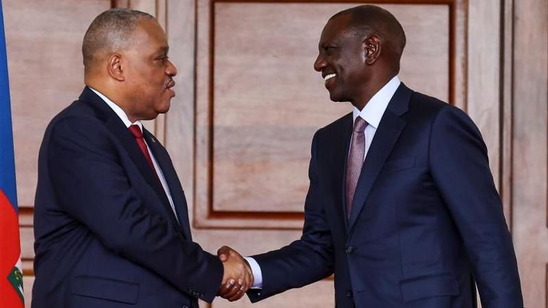 Kenya President William Ruto (R) and Haiti Prime Minister Garry Conille (L) shake hands after addressing a joint press conference during Conille's official state visit, at the Statehouse in Nairobi, Kenya, 11 October 2024.