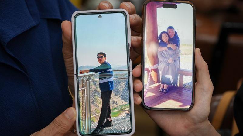 Two phones, held in hands, show still images of an older man, one of them with his arms round a woman.
