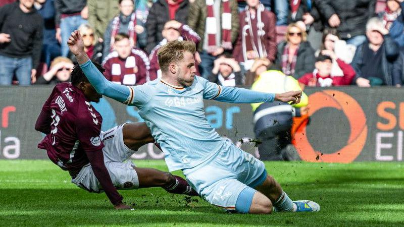 Hearts' Pierre Landry Kabore scores under pressure from Stephen Welsh