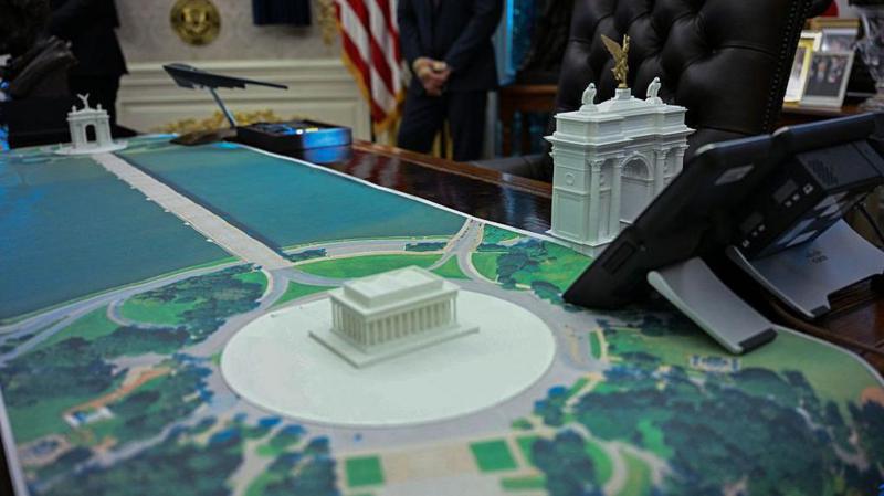 A plan for an arch across from the Lincoln Memorial is seen on the Resolute Desk in the Oval Office