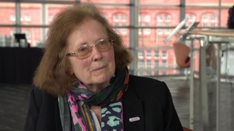 Julie Morgan sat in the Senedd wearing a scarf.