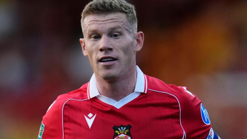 Wrexham star punches rival fan in car park