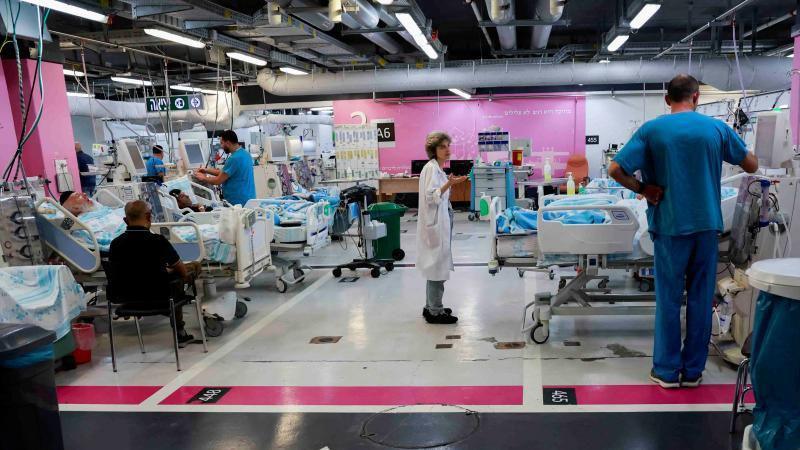 Medical professionals work at an underground emergency hospital in a parking lot in Haifa, northern Israel