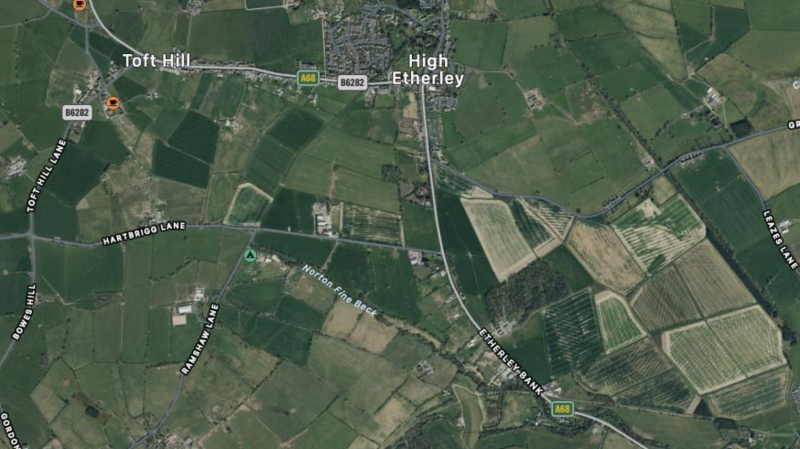 An aerial view of Toft Hill and High Etherley villages in County Durham showing a patchwork of fields and roads. High Etherley is in the centre with Toft Hill to the left, but the latter is a much smaller village 