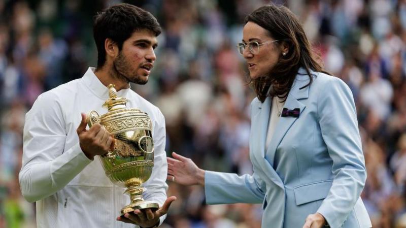 Carlos Alcaraz of Spain talks to AELTC chief executive Sally Bolton while holding the Wimbledon winner's trophy