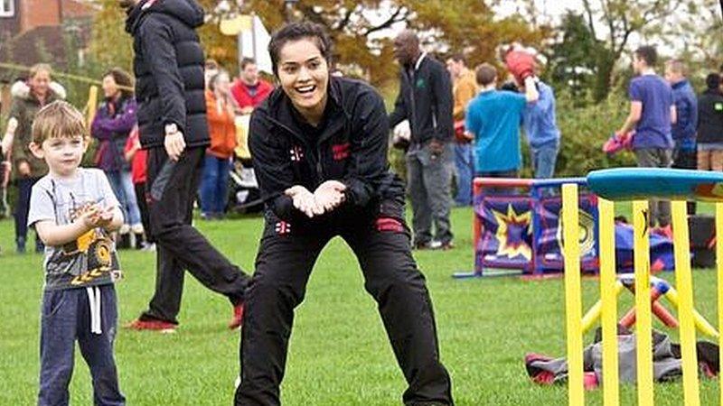 Wicketkeeper Amna Rafiq takes part in a community cricket match