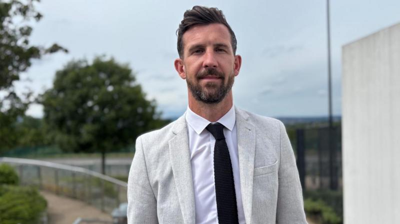 Football star swaps dressing room for classroom