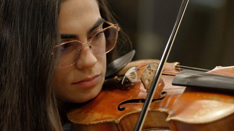 She travelled eight hours by bus for violin lessons. Now she's playing Wembley with Coldplay