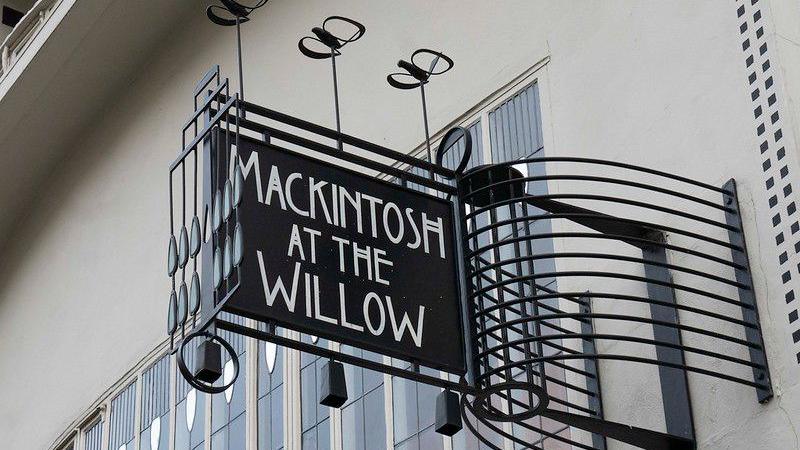 A sign that reads Mackintosh At The Willow. 