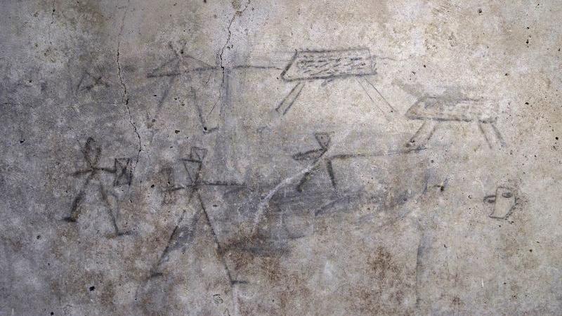 Drawings on a wall in charcoal