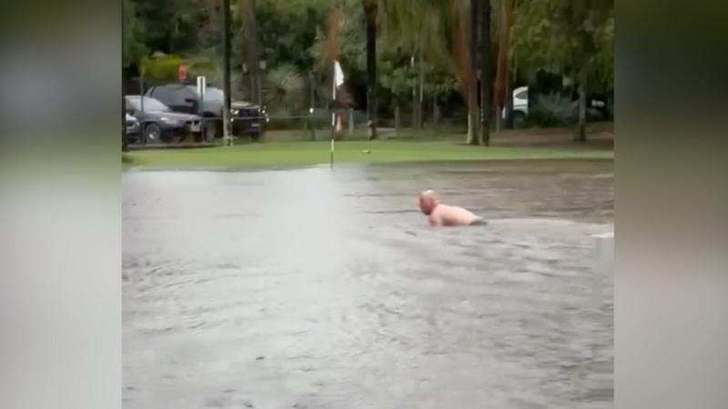 Man swims in flooded Sydney golf course after heavy rain