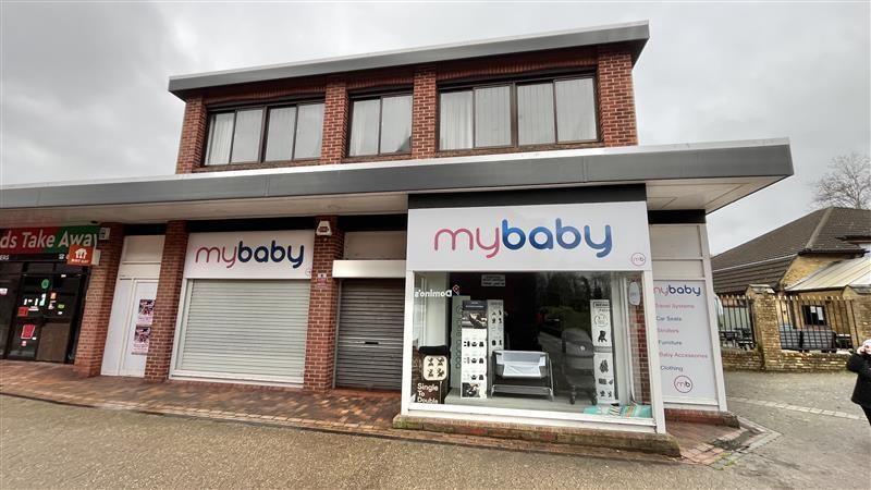 A shuttered mybaby shop in Norwich. It is on the corner of a row of shops and is a two-storey modern building. The shop has two large windows with mybaby written above and a door in between. 