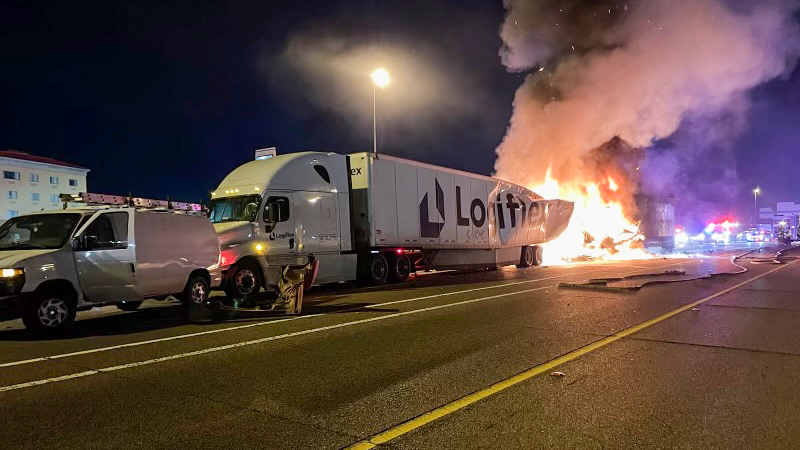 The burning lorry in the aftermath of the crash