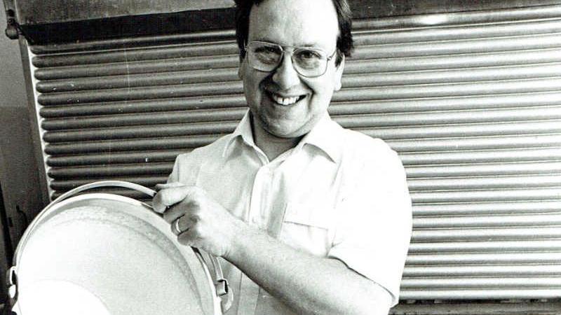 A black and white archive photo of Giulian pouring a bucket of ice cream in the 1980s.