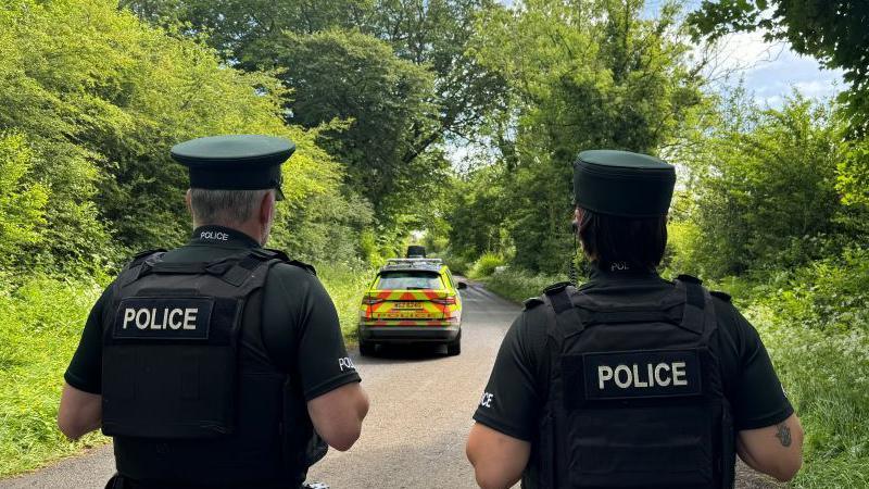 Police officers on  Slievenaghy Road