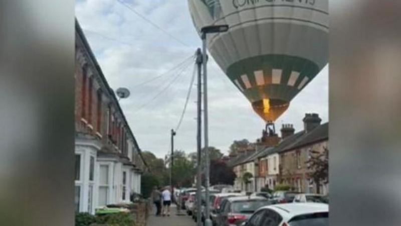 Watch: Hot air balloon lands in residential street