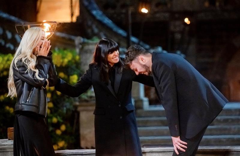 Three people - Leanne, Claudia and Jake - stand together outside, smiling and laughing. They are all wearing black and look in shock