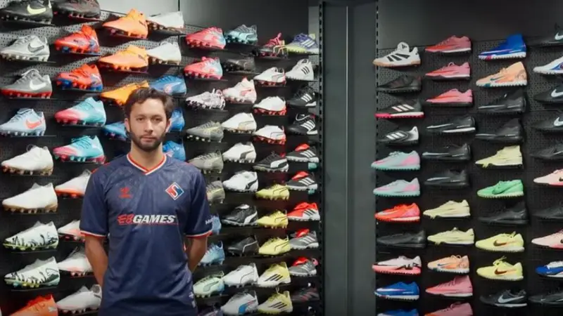 David Choiniere poses in Supra du Quebec's new home shirt inside a football store