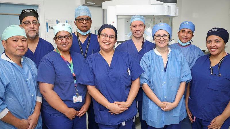 Nine members of the robotic team for the hospital standing together 