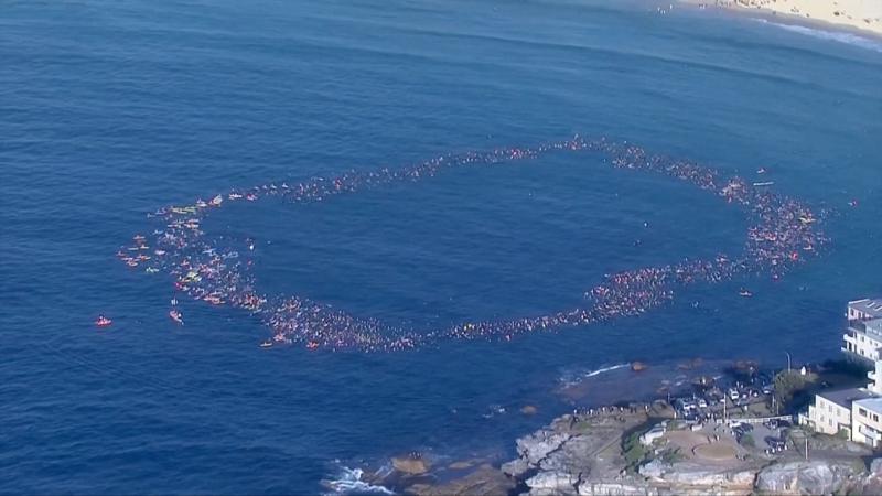 Surfers and swimmers pay tribute to victims of Bondi shooting