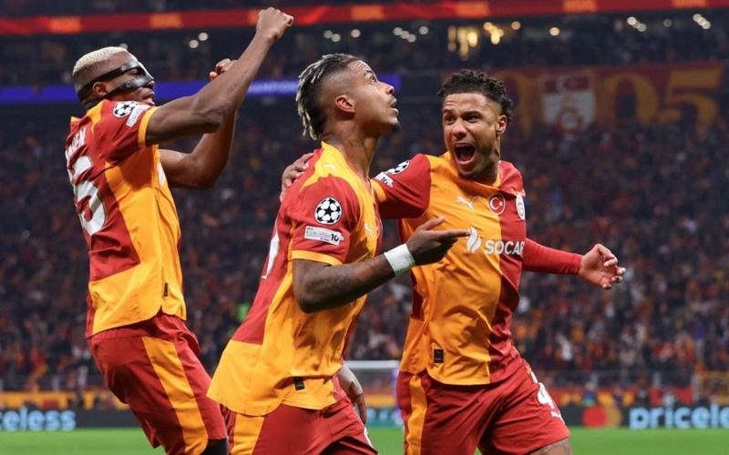 Galatasaray players celebrate scoring against Liverpool in the Champions League