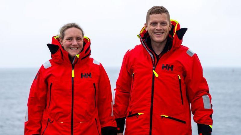 Mhairi and Allan wearing red protective clothing