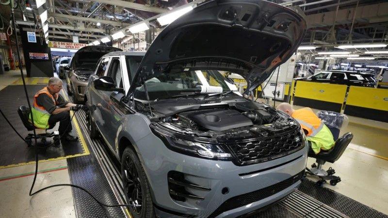 Staff members assemble Range Rover Evoque SUVs on the production line at Jaguar Land Rover's Halewood factory in Liverpool