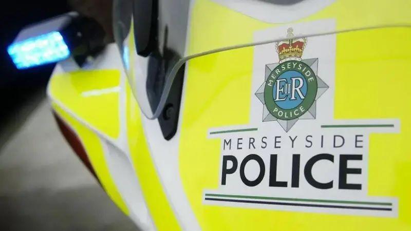 A close up of a yellow police bike bearing the words Merseyside Police including the force's logo