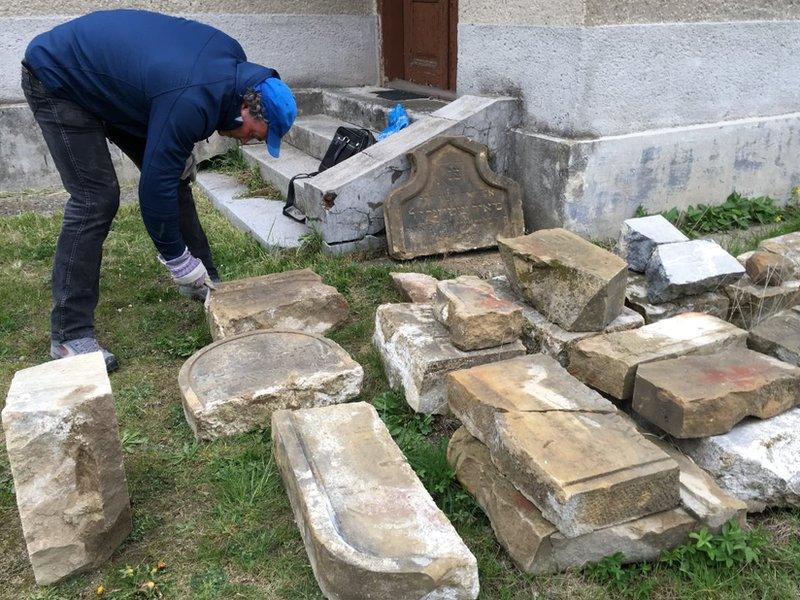 Tomas Jelinek cleaning some of the headstones