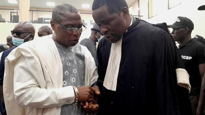 Guinea's former military junta leader Moussa Dadis Camara talks with a lawyer during his trial with ten other men accused of responsibility for the 2009 massacre and mass rape of pro-democracy protesters by forces linked to a former military junta in Conakry, Guinea September 28, 202