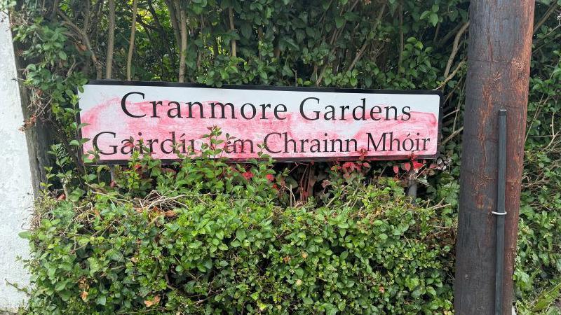 Red paint has sprayed over Cranmore Gardens road sign