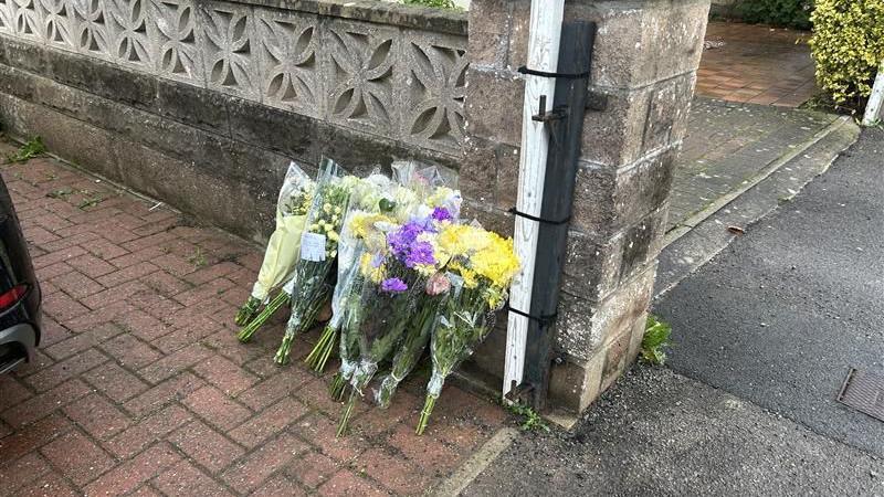 Flowers left on a driveway