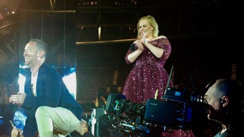 Adele watches the surprise marriage proposal at Melbourne's Etihad Stadium