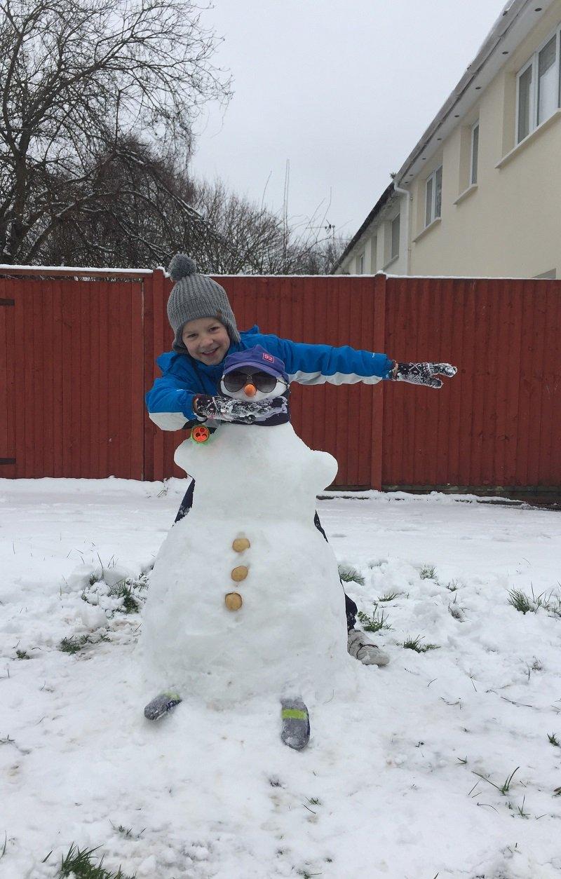 Image of a child with a snowman