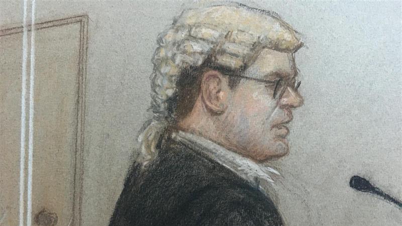 A sketch of prosecuting KC Tom Little in court, wearing glasses and speaking into a microphone.