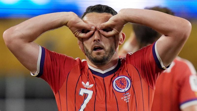 Why does Scotland's McGinn celebrate with goggles?