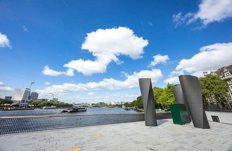 Concrete riverside with the London Eye - a large ferris wheel - in view