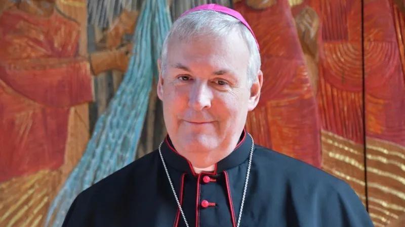 A bishop is smiling towards the camera
